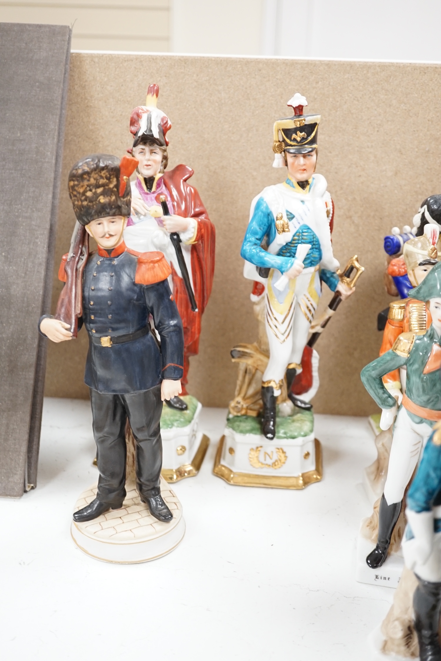 A group of thirteen naval/military figures, tallest 32cm high